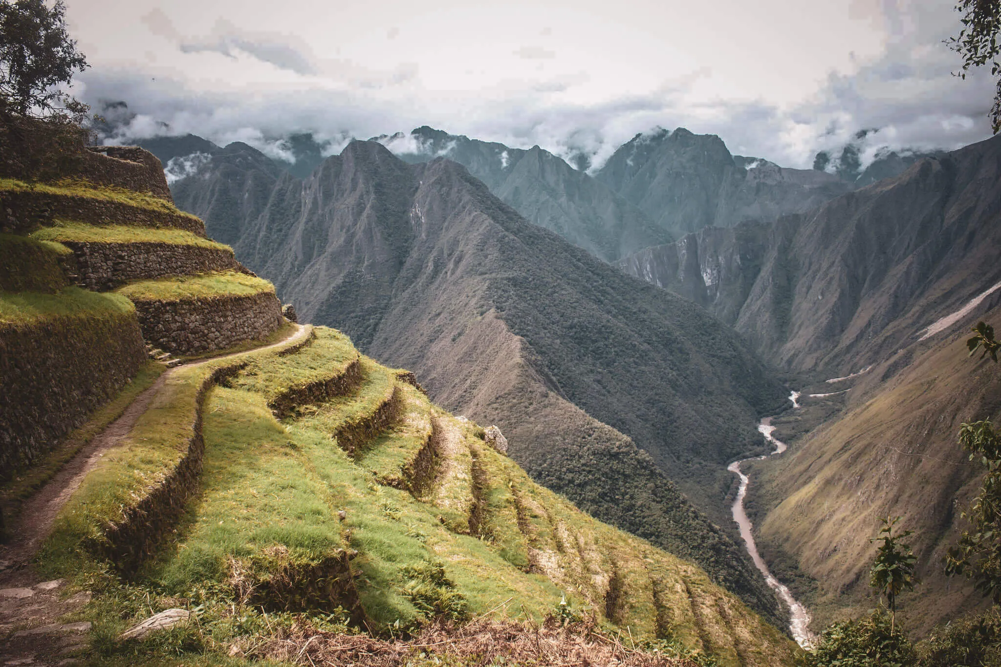 Ancient Inca terraces overlooking a deep Andean valley on the route to Machu Picchu