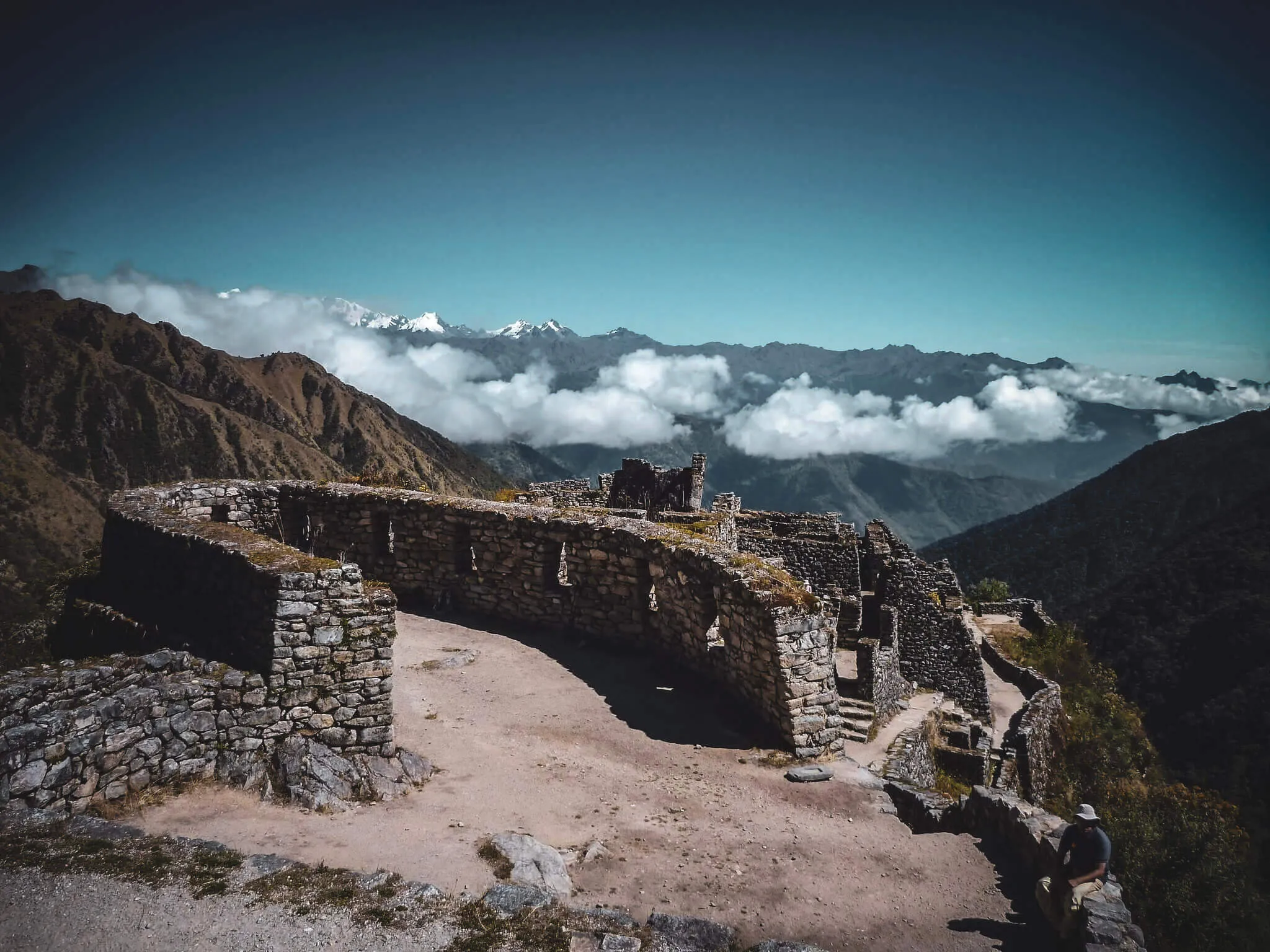 Inca stone buildings integrated into a high mountain ridge on the Classic Inca Trail