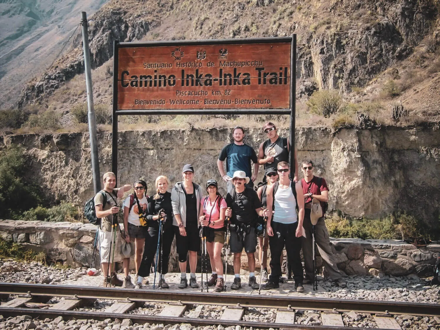 Hikers at the Piscacucho Km 82 starting sign for the Classic Inca Trail