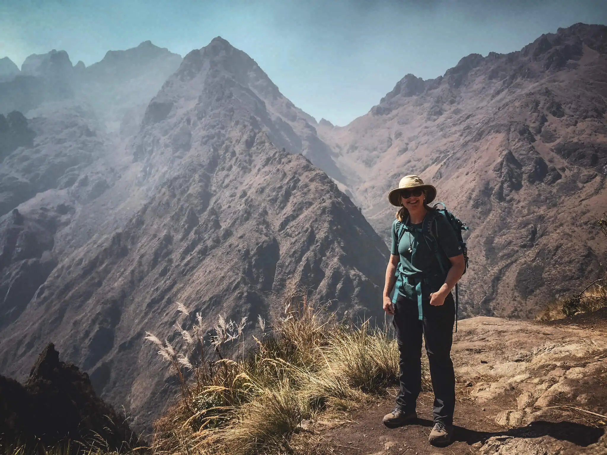 A hiker standing above a dramatic valley on the Classic Inca Trail