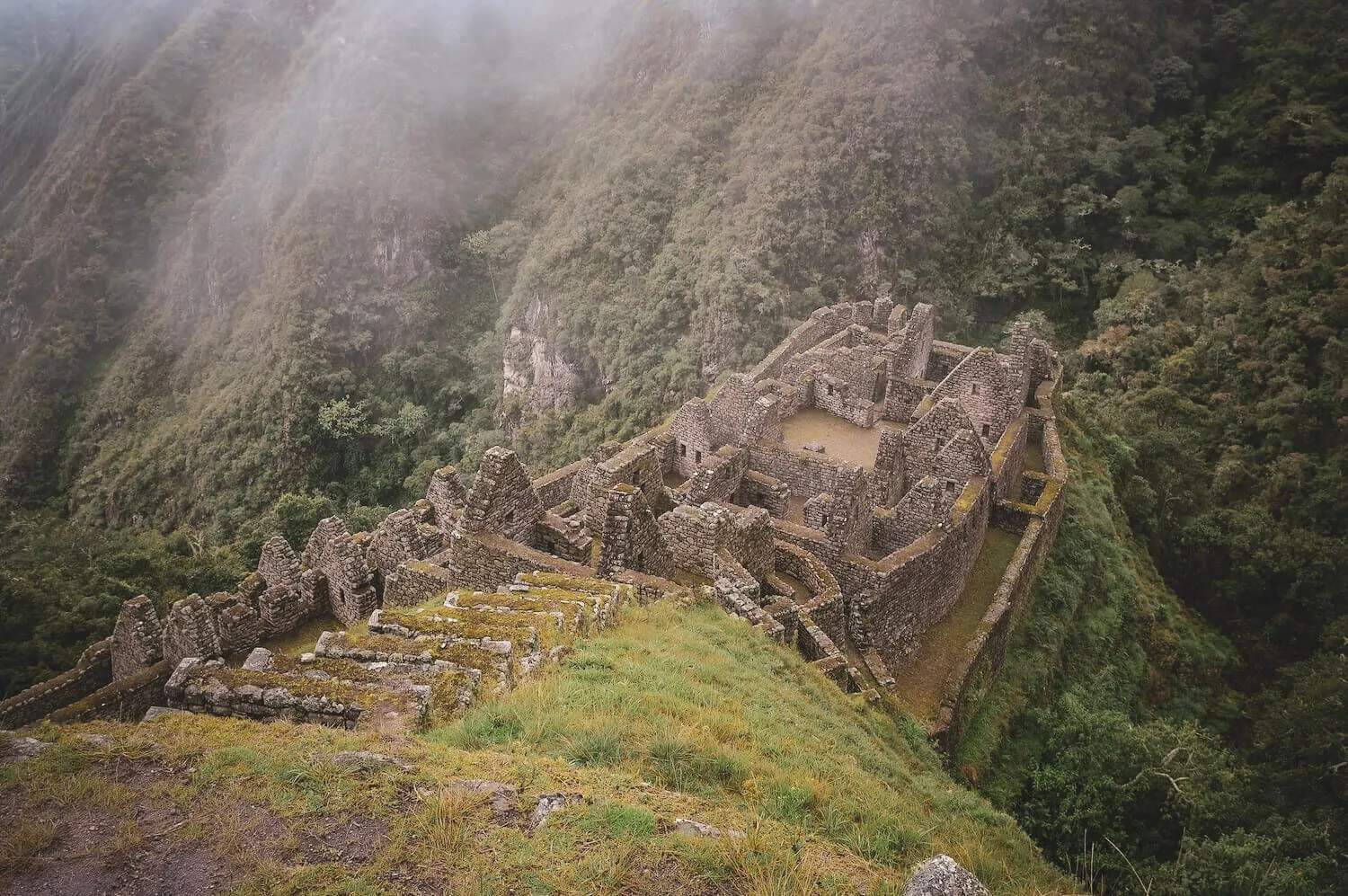 Upper stone enclosures at Wiñay Wayna surrounded by humid mountain forest