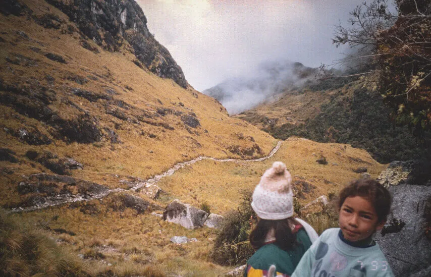 Young hiker walking on a mountain trail in the Cusco Andes